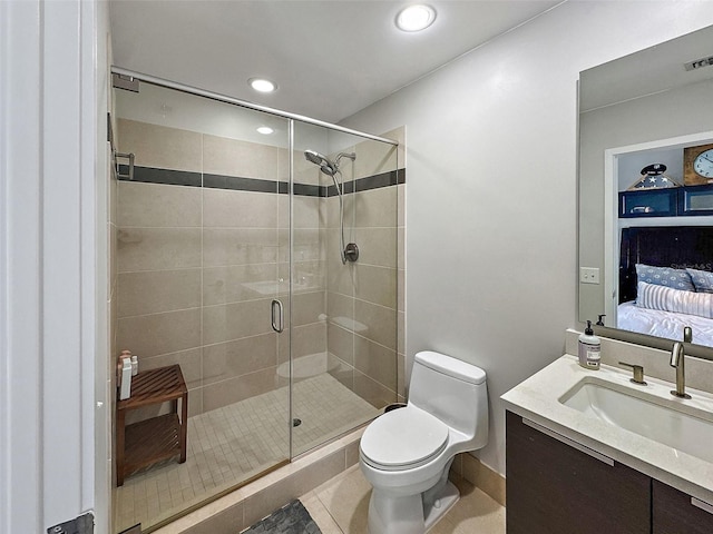 bathroom with vanity, a shower with door, toilet, and tile patterned floors