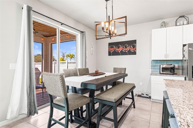 dining space with light tile patterned floors and a toaster