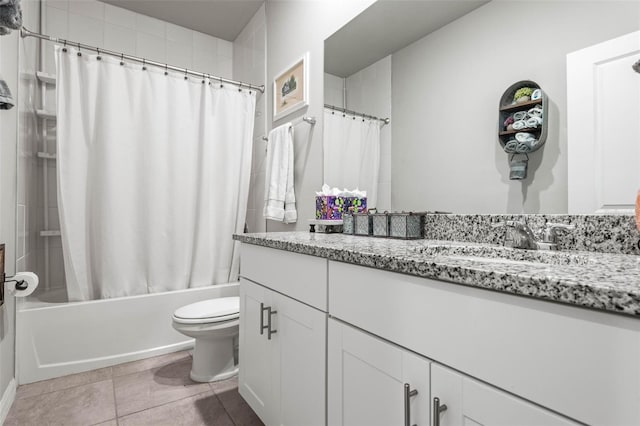 full bath with tile patterned floors, toilet, vanity, and shower / bath combo