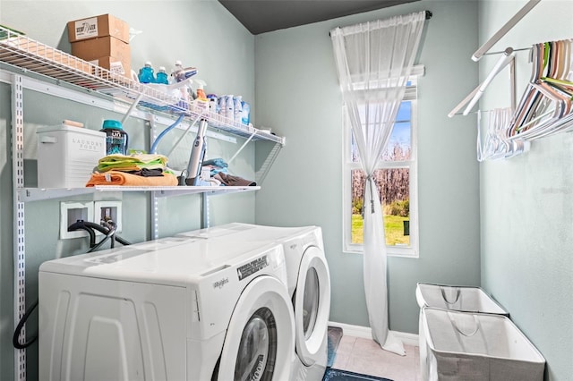 clothes washing area with washer and dryer, baseboards, laundry area, and tile patterned flooring