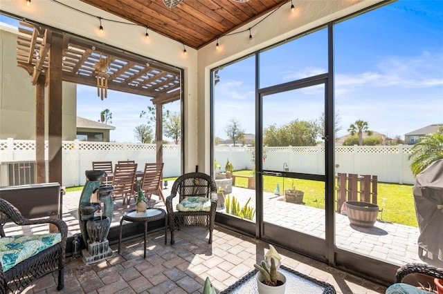 sunroom / solarium featuring wooden ceiling