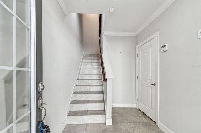 stairs featuring crown molding and tile patterned flooring