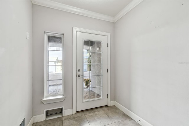 entryway with ornamental molding and light tile patterned floors