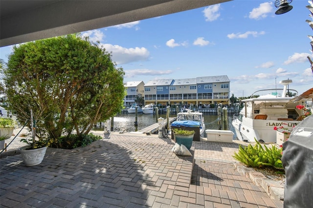 view of patio / terrace featuring a water view and a boat dock