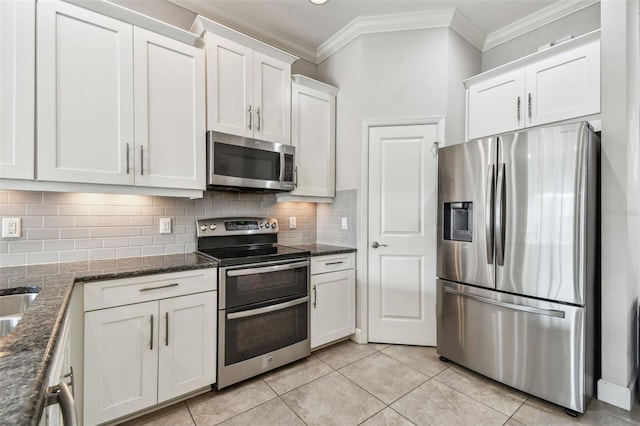 kitchen with ornamental molding, white cabinets, stainless steel appliances, and decorative backsplash