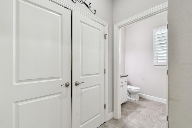 bathroom featuring toilet, vanity, and tile patterned flooring