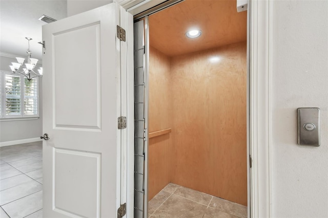 room details with elevator and a chandelier