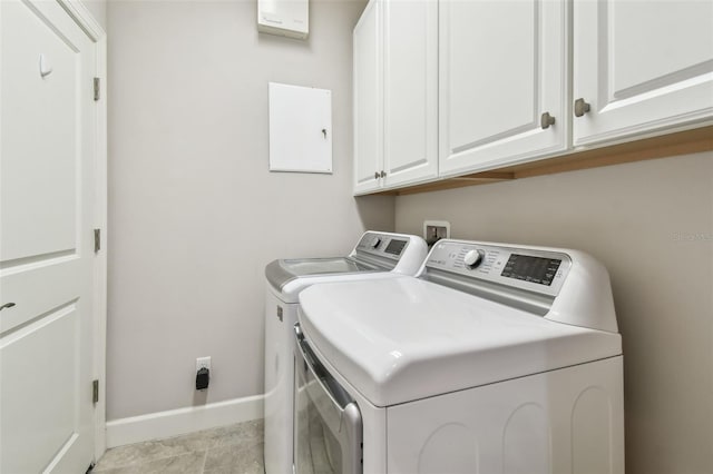 laundry room featuring washing machine and dryer and cabinets