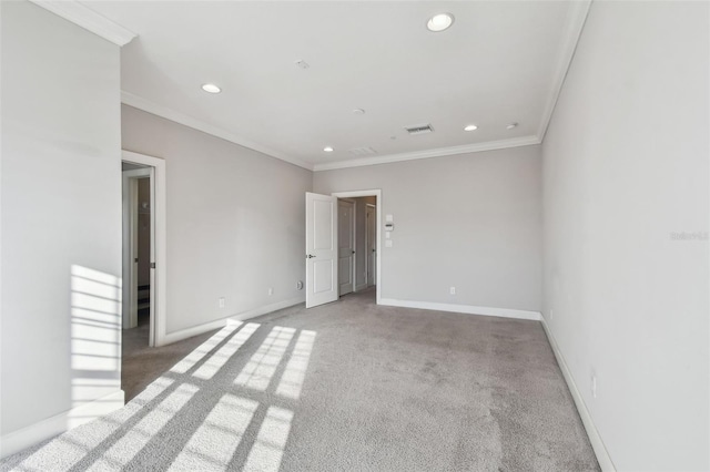 spare room featuring crown molding and light colored carpet