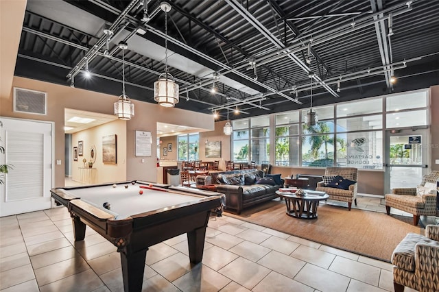 game room with billiards, tile patterned flooring, rail lighting, and a healthy amount of sunlight