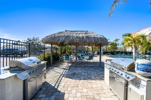 view of patio / terrace featuring a community pool, area for grilling, and grilling area