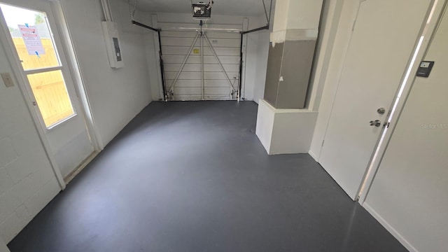 garage with a garage door opener and electric panel