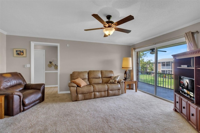living room featuring a ceiling fan, light colored carpet, crown molding, and a textured ceiling
