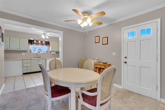 dining space featuring ornamental molding, light colored carpet, baseboards, and light tile patterned flooring