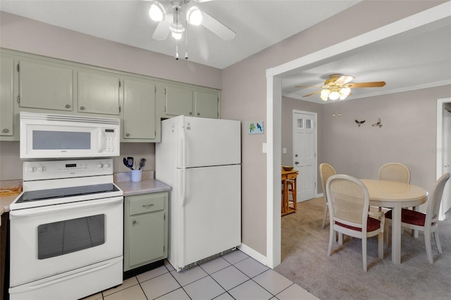 kitchen with white appliances, ceiling fan, ornamental molding, light countertops, and green cabinets