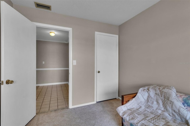 tiled bedroom with carpet floors, baseboards, and visible vents