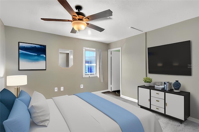 bedroom featuring ceiling fan, baseboards, and light colored carpet