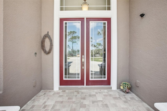 entrance to property featuring stucco siding