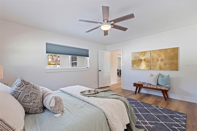 bedroom with baseboards, a ceiling fan, and wood finished floors