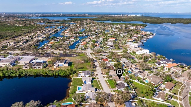 drone / aerial view featuring a water view and a residential view