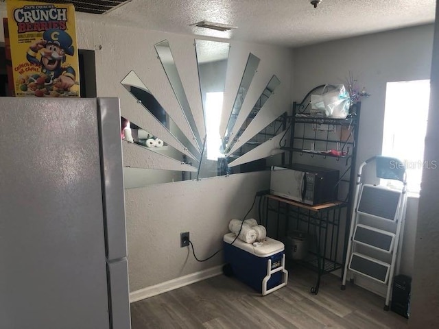 miscellaneous room featuring wood finished floors and a textured ceiling