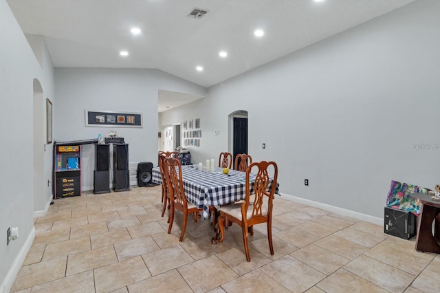 dining area featuring lofted ceiling and light tile patterned floors