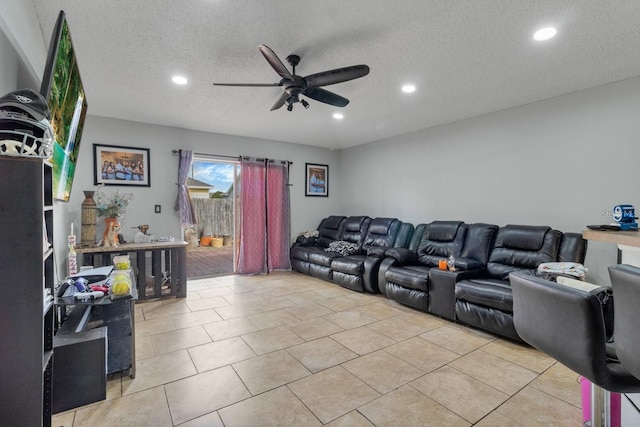 tiled living room featuring ceiling fan and a textured ceiling