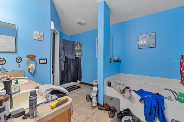 bathroom featuring tiled bath, tile patterned floors, and vanity