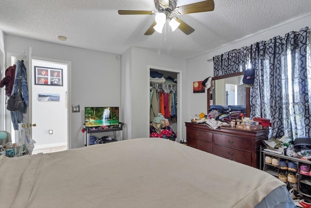 bedroom featuring a textured ceiling, a closet, and ceiling fan