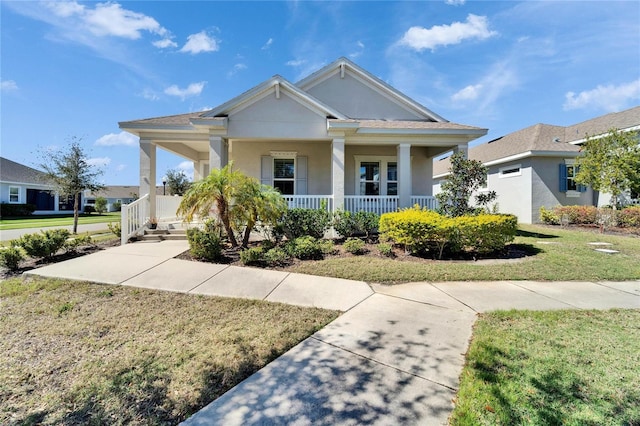 view of front of house featuring covered porch and a front lawn