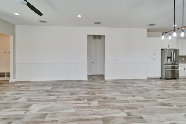 unfurnished living room featuring light hardwood / wood-style floors and ceiling fan