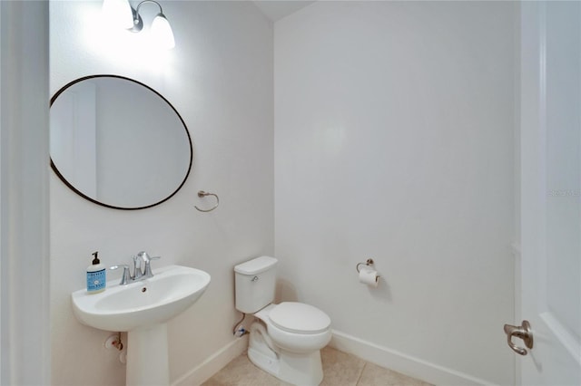 bathroom with sink, tile patterned flooring, and toilet