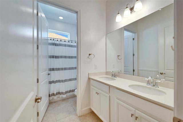 bathroom with toilet, vanity, tile patterned flooring, and a shower with curtain