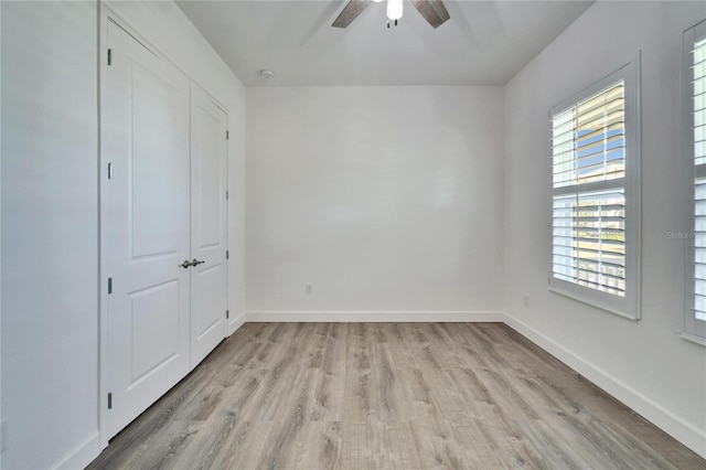 unfurnished bedroom with light wood-type flooring and ceiling fan