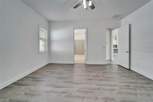 empty room featuring light wood-type flooring and ceiling fan