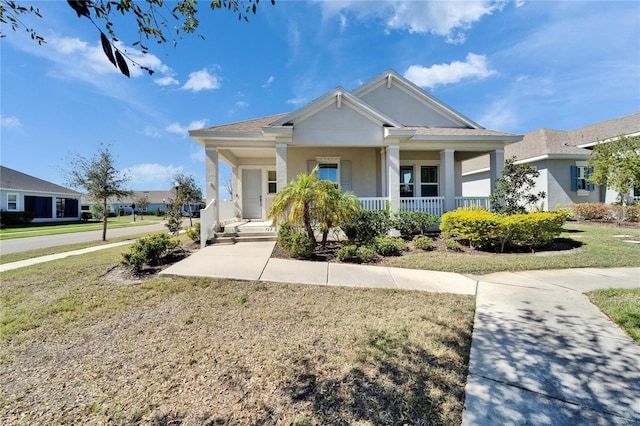 view of front of house featuring covered porch and a front yard