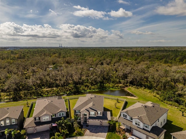 birds eye view of property featuring a water view, a residential view, and a view of trees