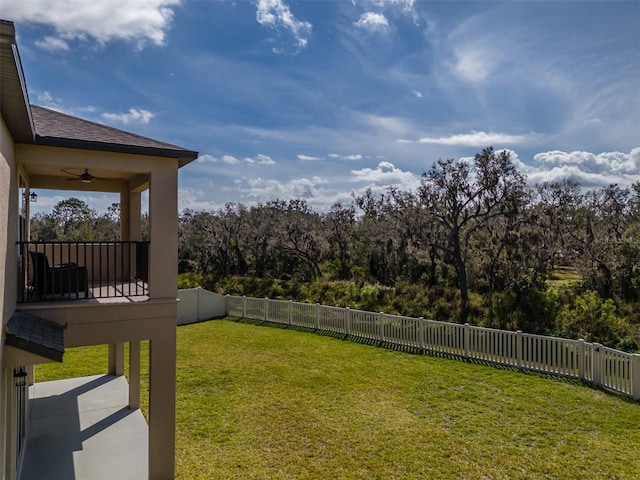 view of yard with a ceiling fan and a fenced backyard