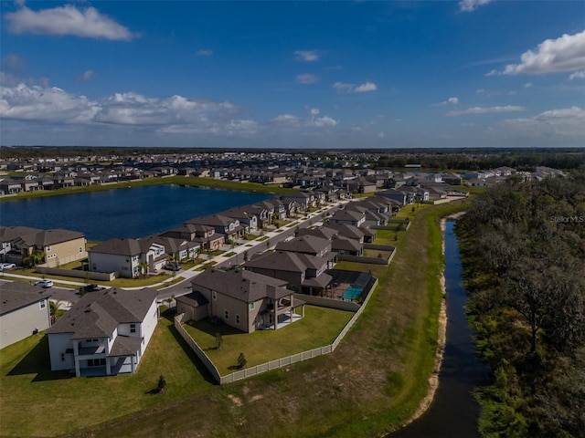 birds eye view of property with a water view and a residential view