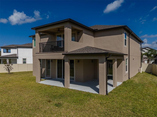 back of house with a yard, a fenced backyard, a patio, and stucco siding