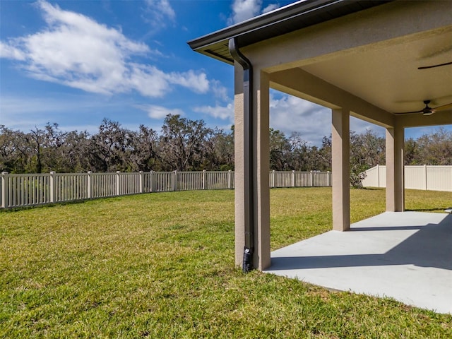 view of yard featuring a ceiling fan, a fenced backyard, and a patio