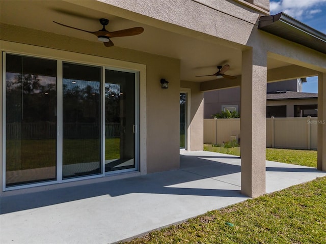 view of patio featuring ceiling fan and fence