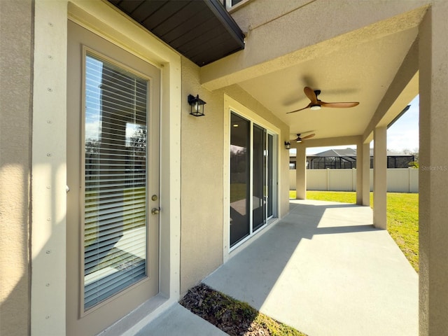 view of patio with fence and a ceiling fan