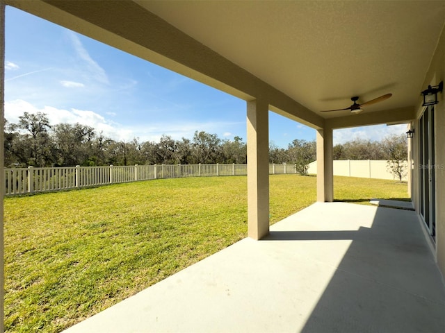 view of yard featuring a ceiling fan, a fenced backyard, and a patio