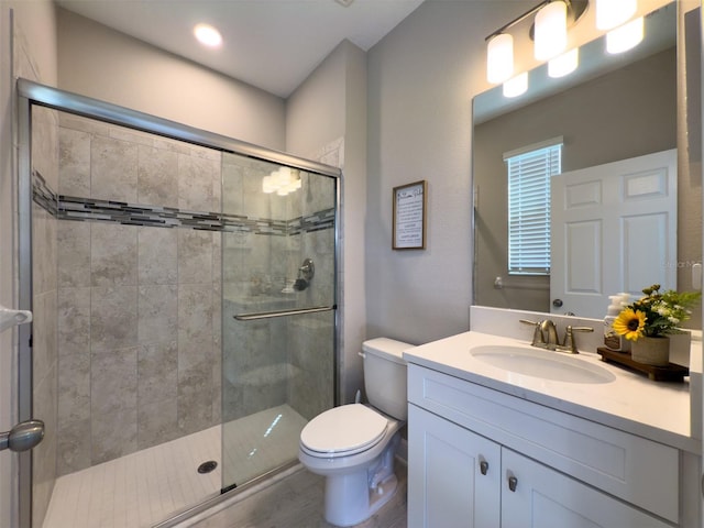 full bath featuring a shower stall, toilet, and vanity