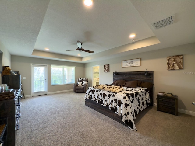 carpeted bedroom featuring recessed lighting, visible vents, access to exterior, baseboards, and a raised ceiling