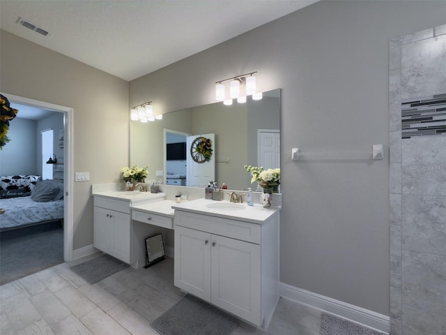 ensuite bathroom featuring ensuite bathroom, vanity, visible vents, and baseboards