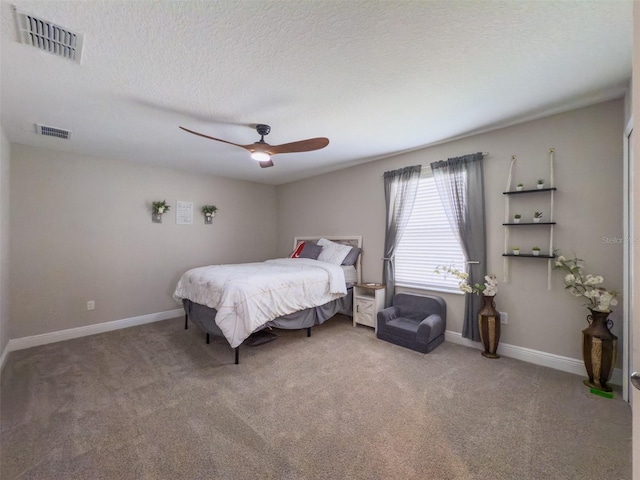 bedroom featuring visible vents, a textured ceiling, and baseboards