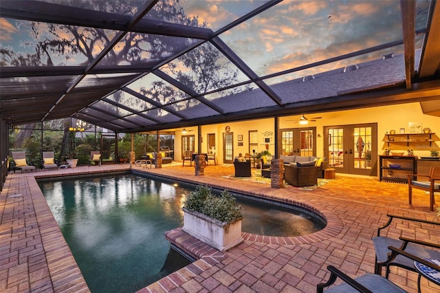 pool with an outdoor living space, a patio, and french doors