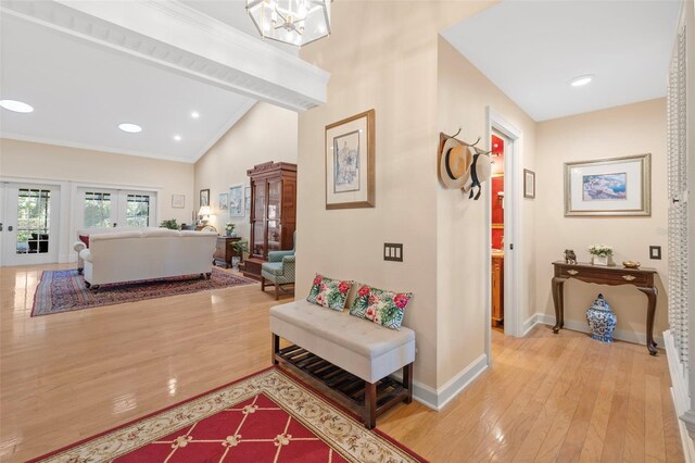 hallway with lofted ceiling with beams, recessed lighting, baseboards, light wood-style floors, and ornamental molding